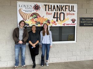 Brayden Alford, Emily Snodgrass, and Fannie Johnson standing outside Loves Kitchen
